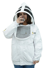 Female beekeeper drinking water with fencing veil flipped open on white poly-cotton beekeeping jacket