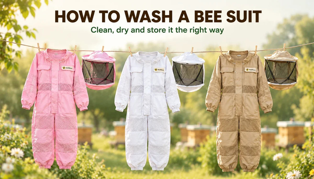 Pink, white and khaki Mellifera bee suits with detached veils hanging on a clothesline to air dry after washing