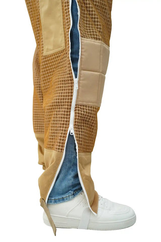 Close-up of khaki 3-layer mesh beekeeping trousers with full-length side zipper open and ankle strap
