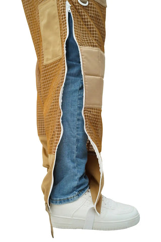 Full-length side zipper of khaki 3-layer mesh beekeeping trousers open revealing clothing underneath
