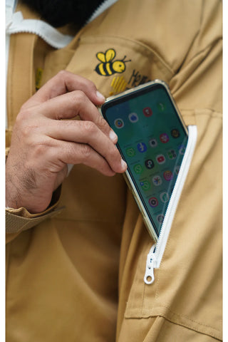 Close-up of the chest pocket holding a smartphone on the khaki poly cotton beekeeping suit