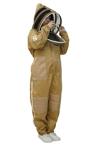 Beekeeper drinking water through the fencing veil of the khaki poly cotton beekeeping suit