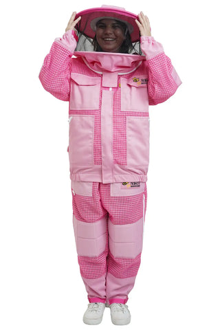 Beekeeper putting on the round hat veil of the pink 3 layer ventilated mesh beekeeping jacket and trouser set, front view