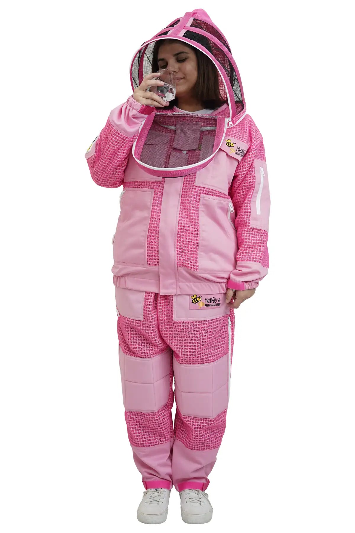 
Beekeeper drinking water through the round veil of the pink 3 layer ventilated mesh beekeeping jacket and trouser set
