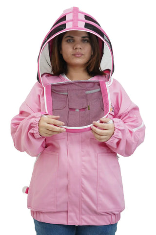 Beekeeper putting on the fencing veil of the pink poly cotton beekeeping jacket, front view