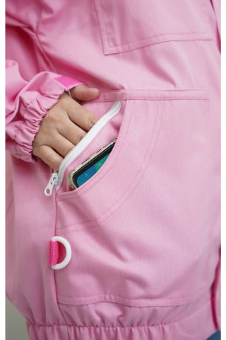 Close-up of the side zip pocket holding a smartphone on the pink poly cotton beekeeping jacket