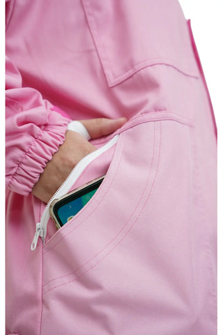Close-up of the side zip pocket holding a smartphone on the pink poly cotton beekeeping suit