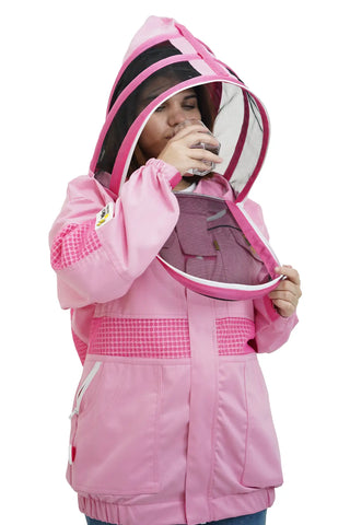 Beekeeper drinking water through the round veil of the pink poly cotton semi ventilated beekeeping jacket